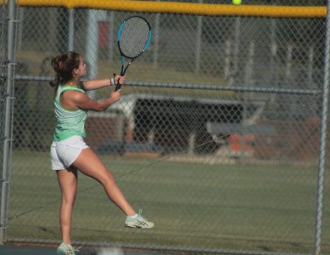 Senior Leah Harding spins a forehand across the net to her opponent. Harding completed her final season being an inspiration to her teammates.