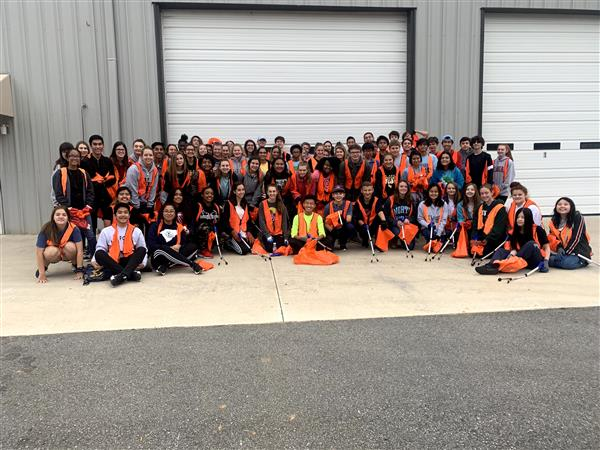 Key Club taking a group photo. Key Club comes together after working hard.