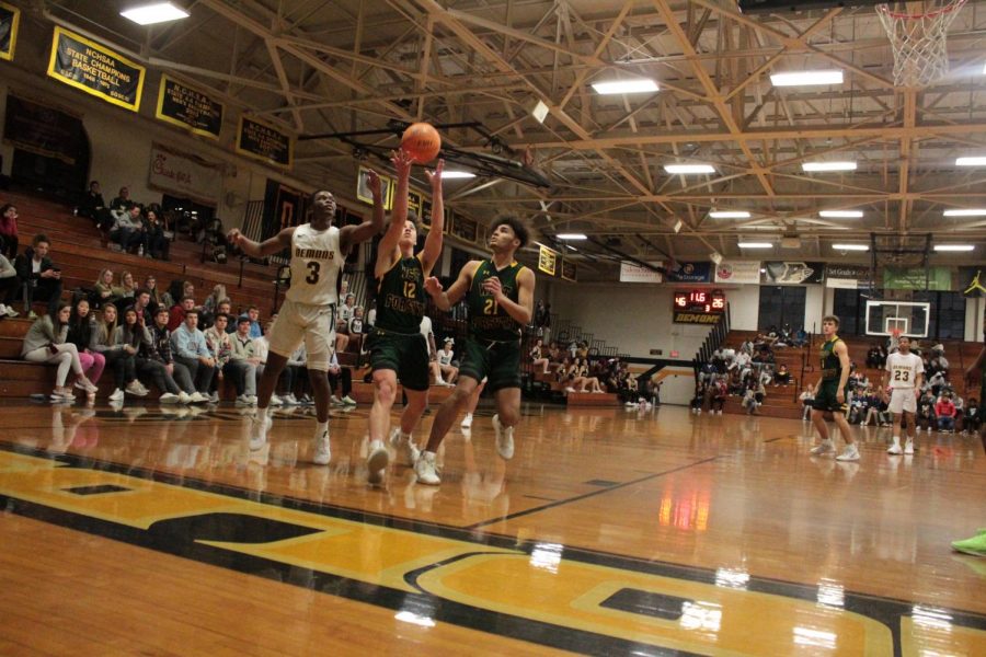 Jake Hill rebounds the ball in front of a Reynolds opponent. Hill will play a pivotal role on the team this year as one of two returning starters and a verbal leader for the other players.