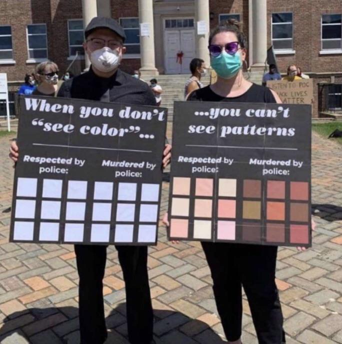 BLM protesters seen holding a sign that depicts why people shouldn't say they "don't see color".