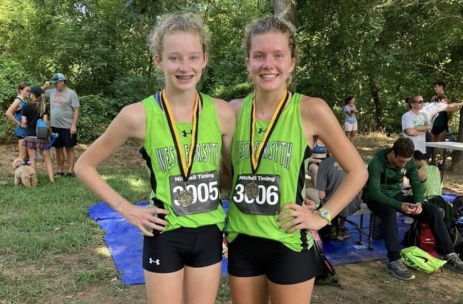 Lily and Tenley Douglass posing with their medals awarded for placing top 20 at the Providence Invitational Meet at McAlpine Park. 