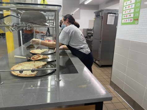 Cafeteria worker, Dana Martinez, works hard 
 to serve students. 