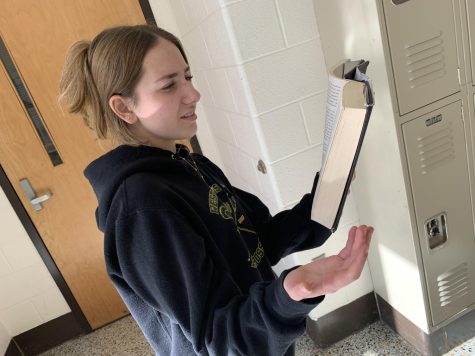 A student reading a book thats so bad its good.