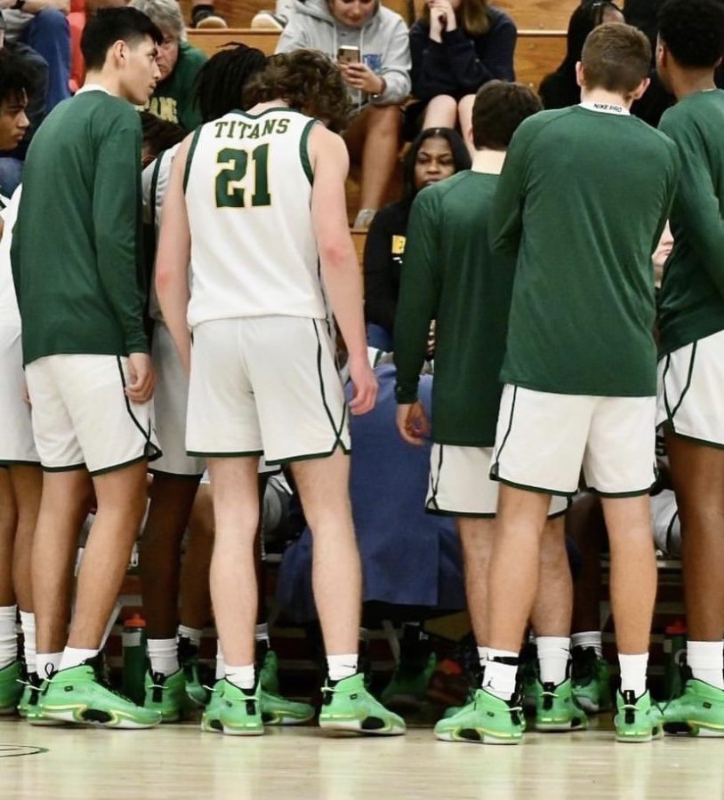 The mens basketball team makes adjustments during a time out