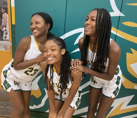 (from left to right) Girls Varsity Basketball players Binta Barry, Nia Gary and Genysis Howard posing for a photo before getting ready to play a game.
