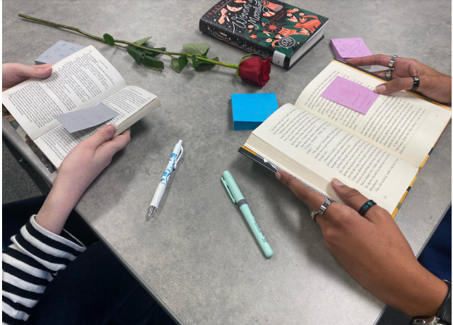 Two West students annotate books on a date.