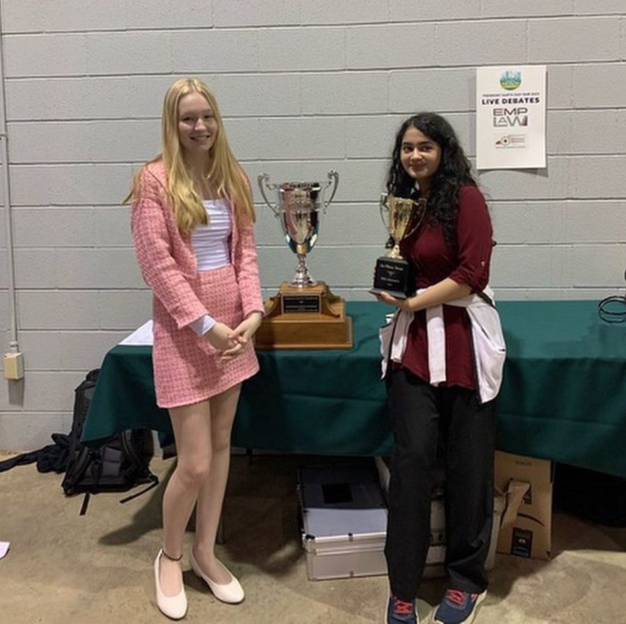 Chloe+Phelps+%28junior%29+and+Minna+Siddiqui+%28senior%29+proudly+stand+with+their+Speech+and+Debate+competition+trophy