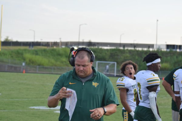 Coach Wallace looking over his play sheet during the game against Oak Grove that the Titans would go on to win 40-29.