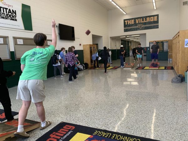 Corn Hole Club member, Hudson Delphias tosses bag.