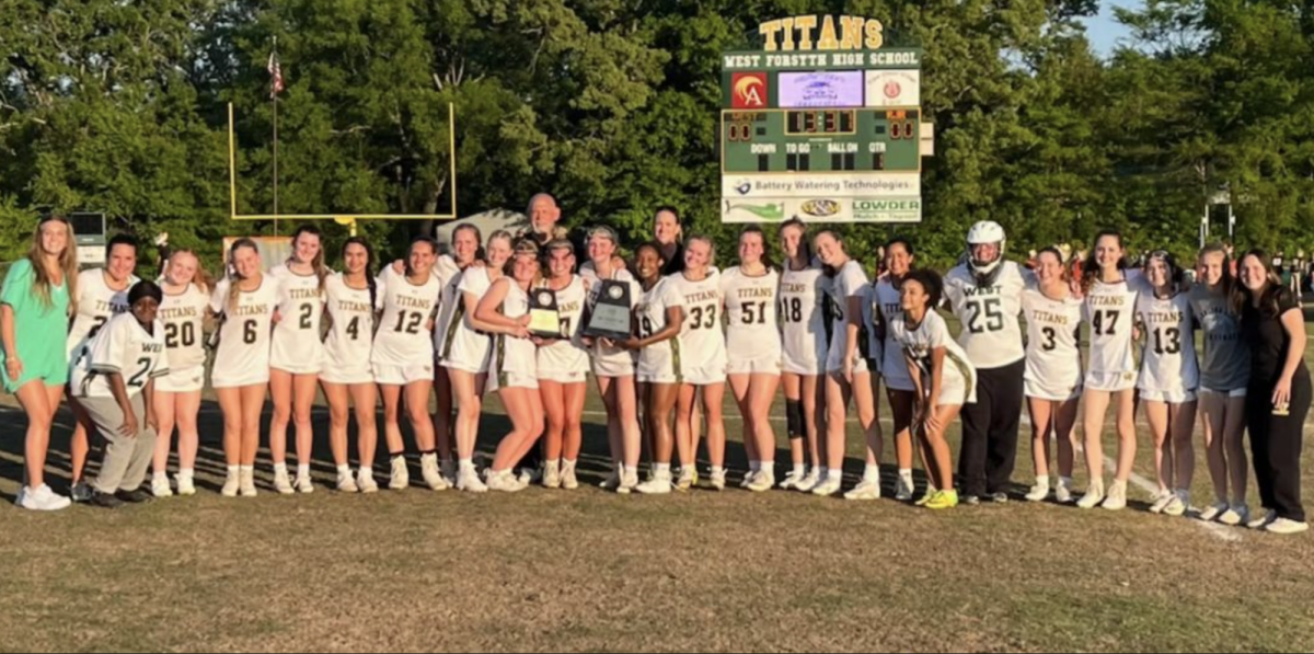 The+girls+lacrosse+team+taking+a+photo+with+both+the+CPC+regular+season+and+CPC+tournament+trophies.+%28Photo+courtesy+of+%40wfgirlslax+on+Instagram%29