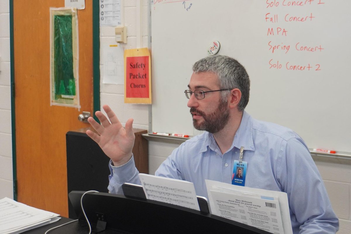 Jacob Cook teaching chorus class.