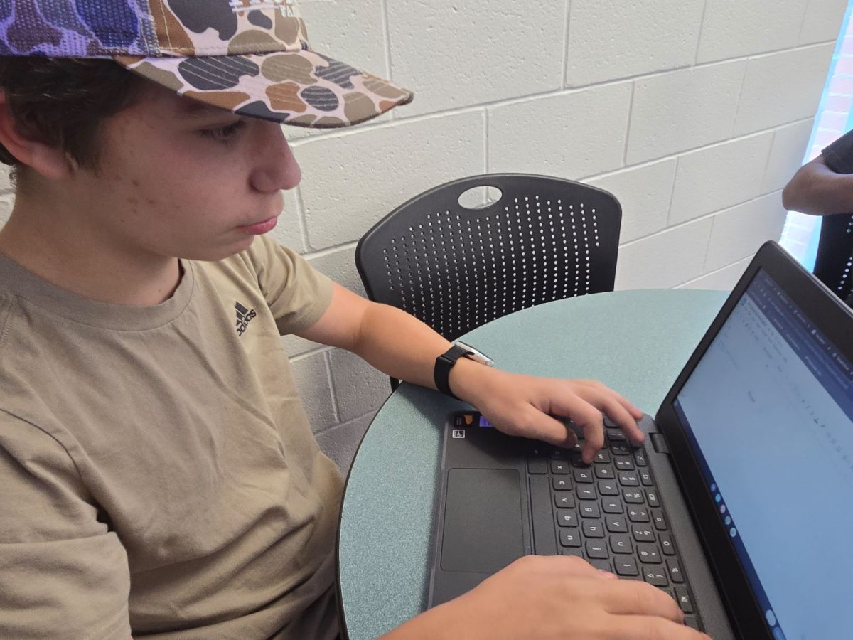 West student doing his school assignments on his computer