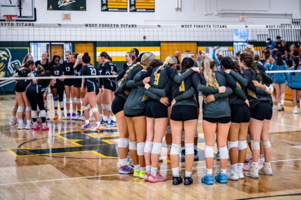 West Forsyth's girls' volleyball team in a huddle.