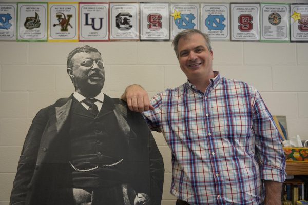 Mr. Dunham posing with Theodore Roosevelt cardboard cutout.