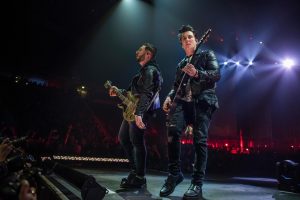 Avenged Sevenfold on stage at a concert.