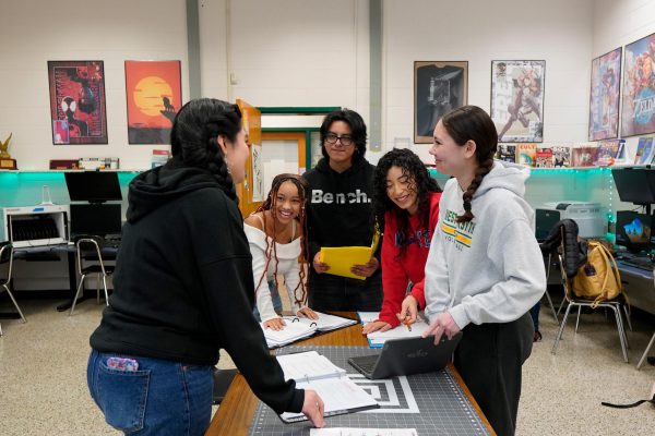 YPA students hold a meeting discussing the success of the bake sale.